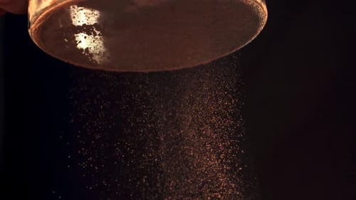 Sifting Cocoa Powder Through a Strainer Close Up