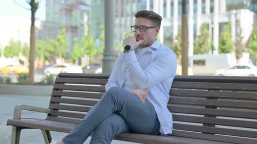 Pensive Man Thinking While Sitting Outdoor on Bench