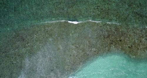Daytime birds eye island view of a sunshine white sandy paradise beach and blue ocean background in