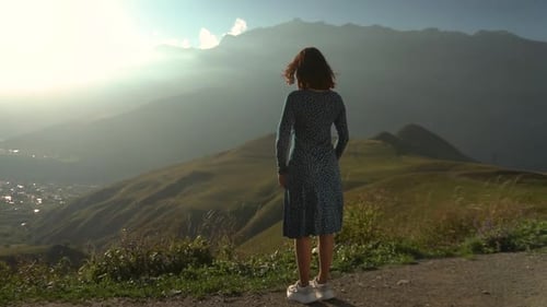 Woman Embracing Mountain View at Sunrise