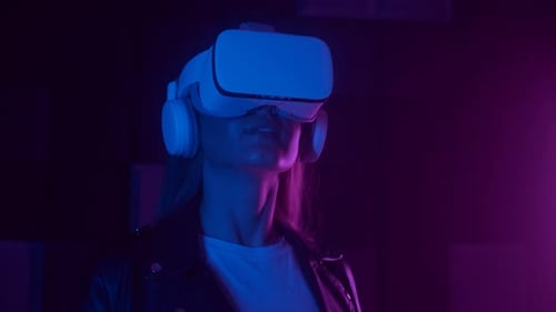 Woman Experiencing Virtual Reality Headset in Neon Lighting