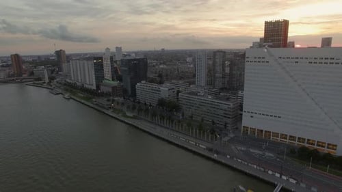 Aerial view of cityscape with modern buildings on the river against cloudy sky