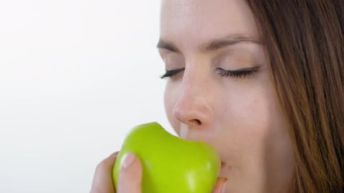 Face of Woman Enjoying Green Apple