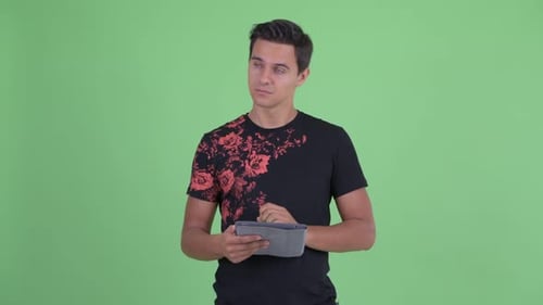 Young Man Uses Tablet Device