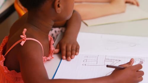 Girl Drawing in School Classroom