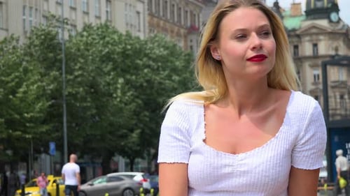 A Young Beautiful Woman Looks Around an Urban Area with a Smile - Closeup