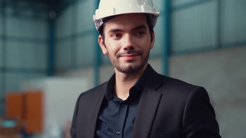 Factory Manager Using Tablet Computer in Warehouse or Factory