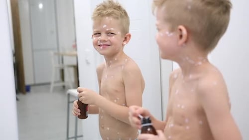 Smiling Boy with Calamine Lotion Spots in Bathroom
