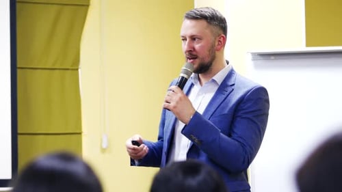 Assertive male politician speaking into microphones on political convention.
