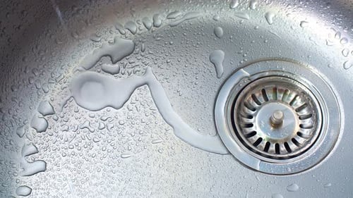 Close-up of Metal Sink with Water Droplets