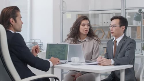 Business Professionals Discussing Project and Shaking Hands