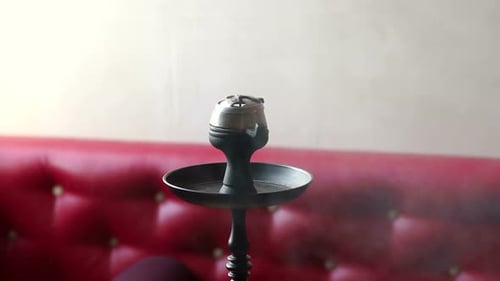 A Modern Glass Hookah Stands on a Table in a Modern Hookah Bar