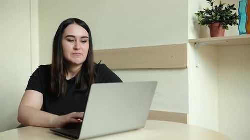 Young Adult Woman Video Calling with Laptop
