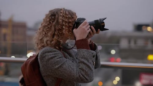 Woman Photographer Make a Photos in City