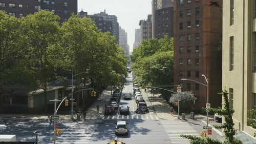 A crossing in New York City, with cars and taxis passing by, top shot