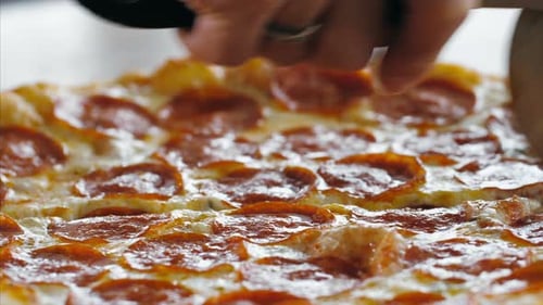 Hands Slice Delicious Pepperoni Pizza With Rolling Cutter