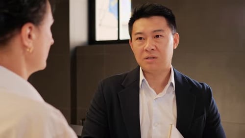 Business Woman Having Negotiation with Asian Male Partner