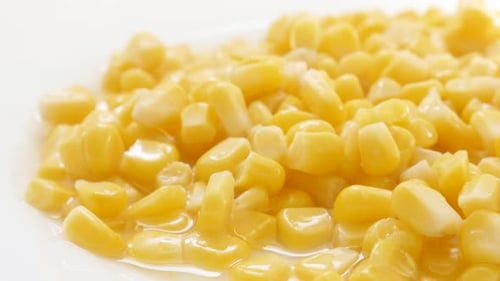 On plate served corn maize kernels from the can close-up 4K 2160p 30fps UHD footage - Canned health