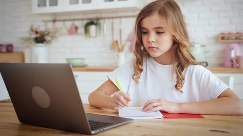 Girl Studying With Laptop in Bright Kitchen