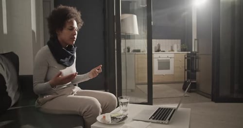 Woman Speaking to Doctor on Laptop at Home