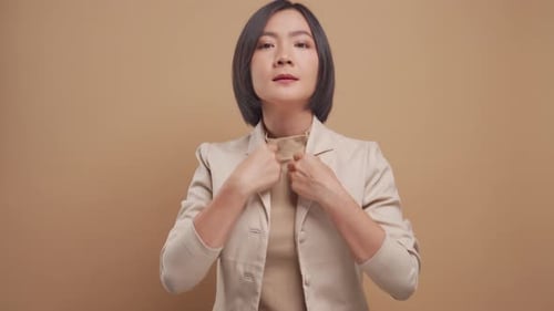 Stylish Woman Buttons Blazer and Crosses Arms