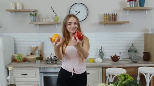 Woman Holding Bell Peppers in Sunny Kitchen