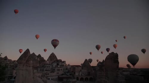 Hot air balloons seen from a cave hotel in Goreme, Cappadocia, at sunrise