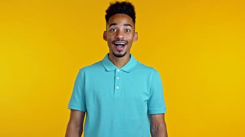 Man Expressing Surprise with Bright Yellow Background
