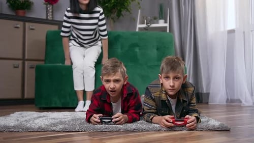 Brothers Play Video Games Together at Home