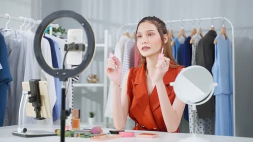 Woman Applies Makeup in Studio for Beauty Vlog