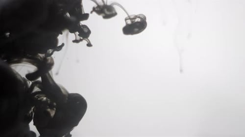 Black Ink Flowing Through Water in Abstract Pattern