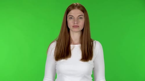 Auburn Haired Woman Posing in Studio with Green Screen
