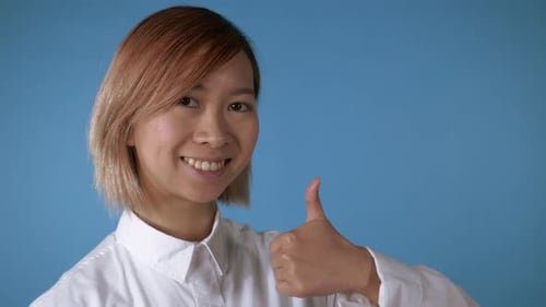 Young Woman Smiling Giving Thumbs Up Approval