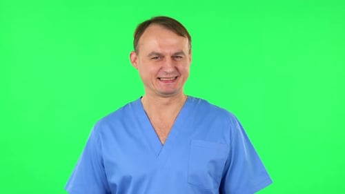 Medical Man Smile and Negatively Waving Her Head Expressing He Is Innocent. Green Screen