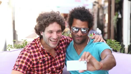 Two Friends Taking a Selfie and Laughing