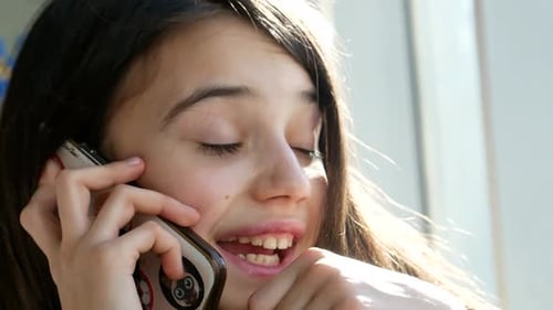 Teen Girl Smiling and Talking on Phone