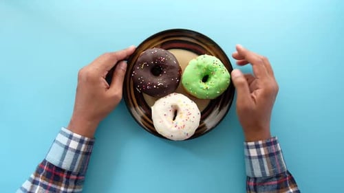 Top View of Hand Holding Donuts