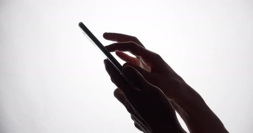 Hands Using Tablet in Silhouette