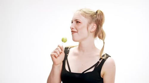 Blonde Woman with Lollipops Posing Playfully