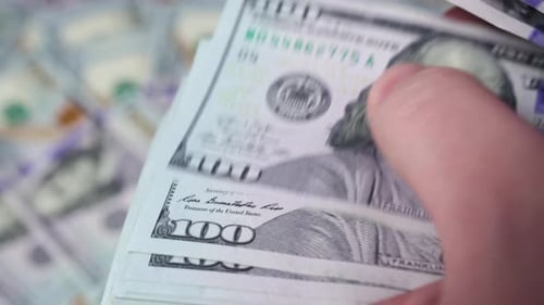 Hand Counting Stacks of One Hundred Dollar Bills