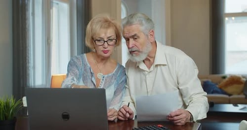 Senior Couple Working on Laptop at Home