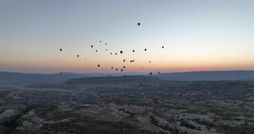 Aerial Cinematic Drone View of Colorful Hot Air Balloon Flying Over Cappadocia