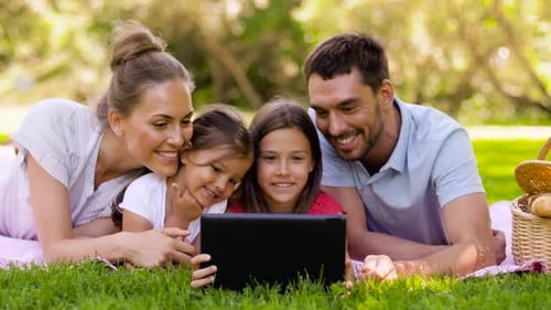 Family with Tablet Pc on Picnic in Summer Park