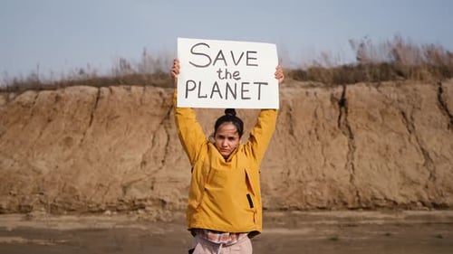 Young Woman Holding Save the Planet Sign
