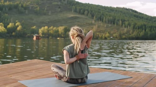 Woman Stretching Shoulders during Outdoor Yoga Practice