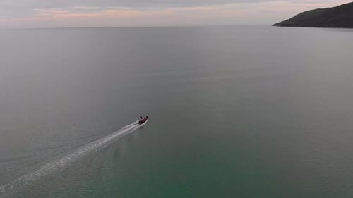 Aerial shot following Thai long tail fishing boat in southern Thailand.