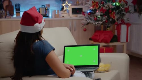 Woman Looking at Horizontal Green Screen on Laptop