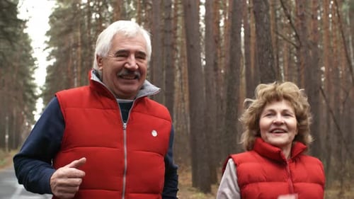 Senior Couple Jogging in Forest