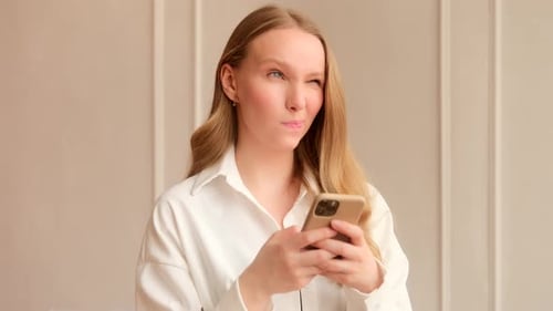 Blonde Woman Using Cellphone Device Indoors