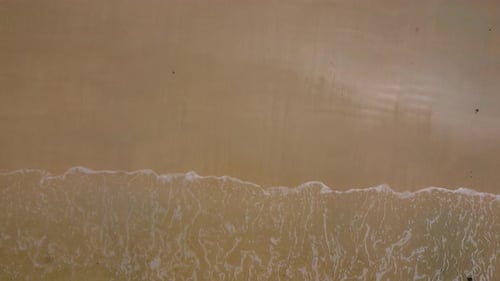 Beautiful sea waves and white sand beach in the tropical island.